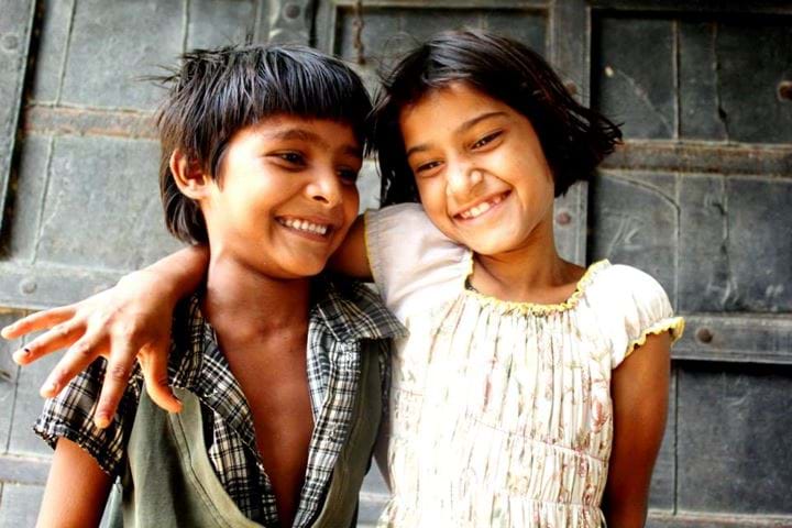 young boy and young girl giggling, India 