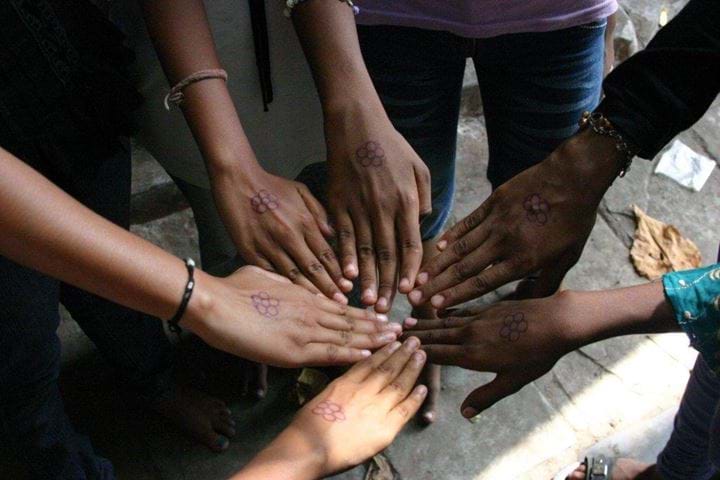 Girls putting hands in together, India 