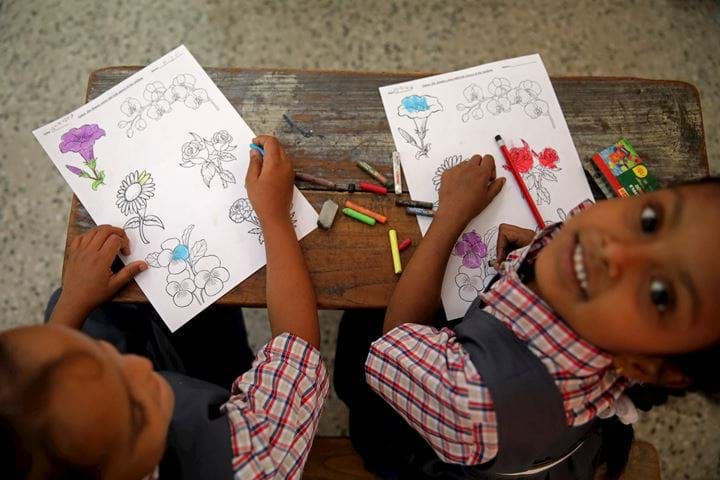 2 young girls in classroom, India 