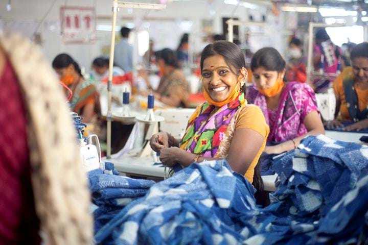 Woman sewing in factory, India