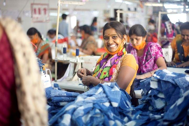 Woman sewing in factory, India 