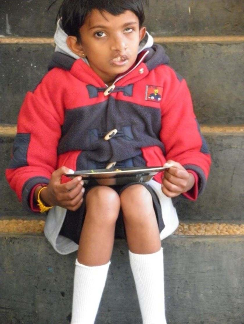 Young child sitting on stairs