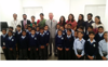 HRH The Prince of Wales posing with school children in India 