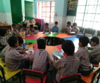 classroom of children on a round table 