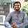 Young man in front of business school, Pakistan  